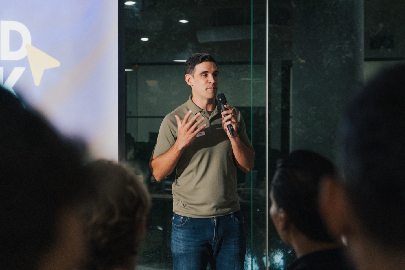Thibault speaking on stage with a microphone